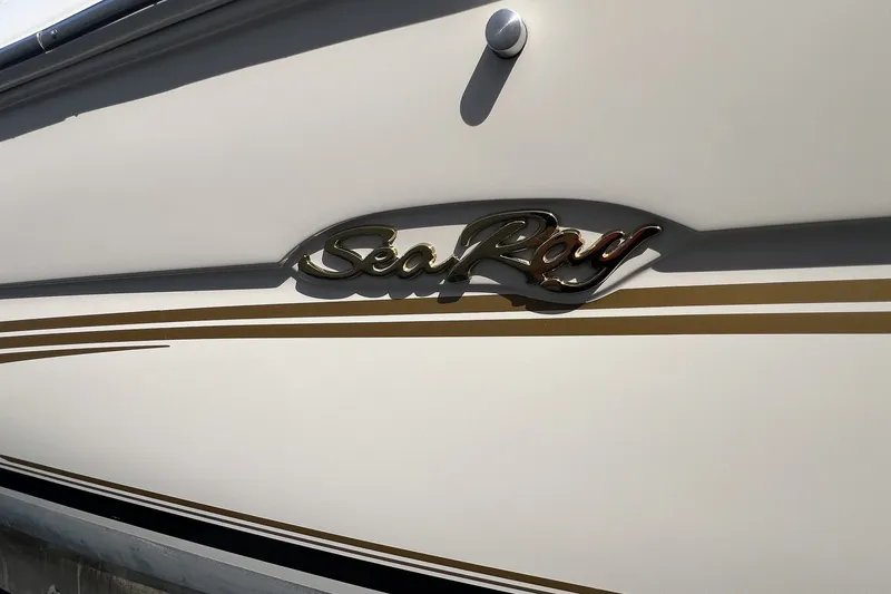 Slide: The Image of 1997 Sea Ray 240 Overnighter boat with gold logo and stripe detail. - 71