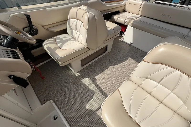 Slide: The Image of Interior of a 1997 Sea Ray 240 Overnighter boat with beige leather seating. - 26