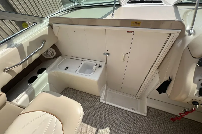 Slide: The Image of Interior of 1997 Sea Ray 240 Overnighter boat, featuring seating and storage area. - 38