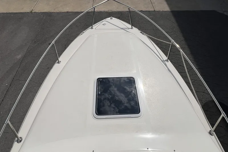 Slide: The Image of Bow view of 1997 Sea Ray 240 Overnighter with hatch and railing. - 32