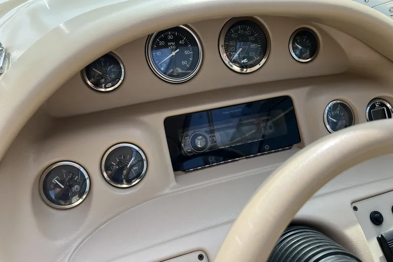 Slide: The Image of Dashboard of a 1997 Sea Ray 240 Overnighter boat with gauges and controls. - 14