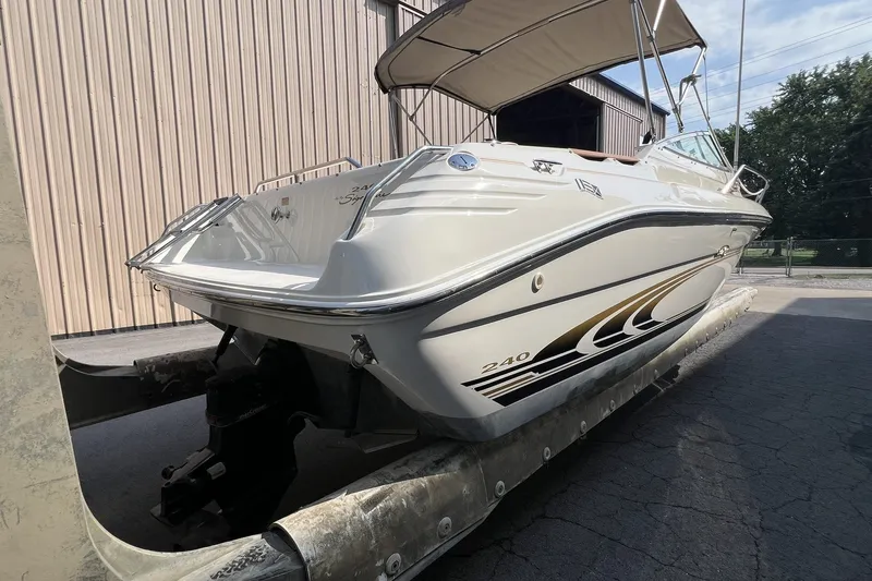 Slide: The Image of 1997 Sea Ray 240 Overnighter boat with canopy, docked outdoors. - 69