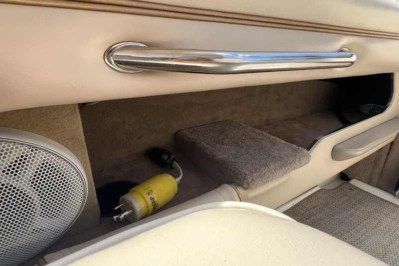 Slide: The Image of Interior of a 1997 Sea Ray 240 Overnighter boat, featuring speaker and storage compartment. - 92