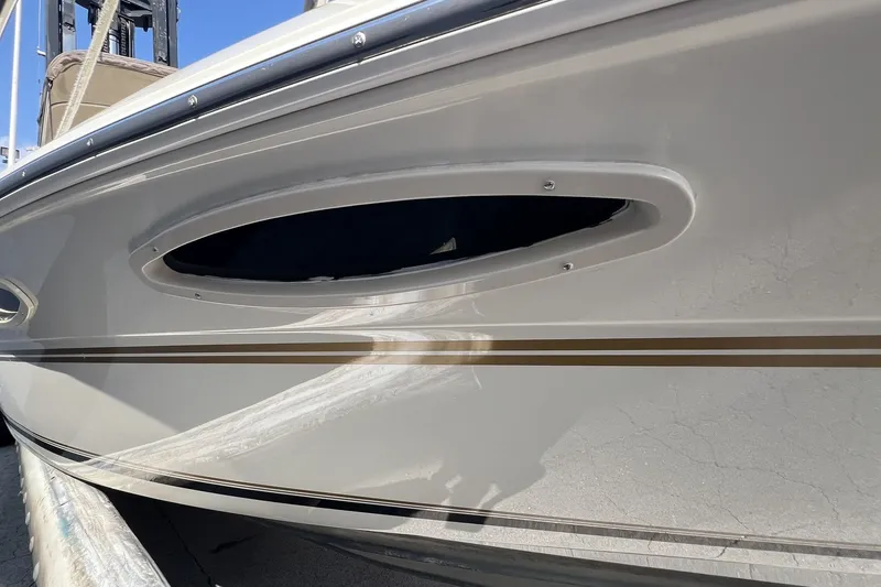 Slide: The Image of 1997 Sea Ray 240 Overnighter boat hull with sleek design and porthole detail. - 75