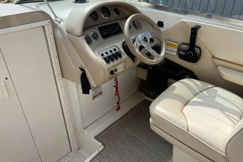 Slide: The Image of Interior cockpit of a 1997 Sea Ray 240 Overnighter boat, featuring steering wheel and controls. - 17