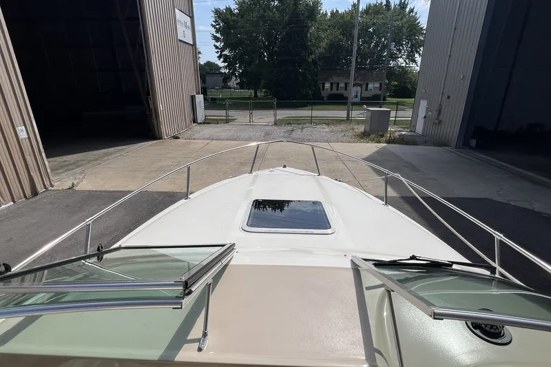 Slide: The Image of 1997 Sea Ray 240 Overnighter boat docked in a marina, viewed from the bow. - 31