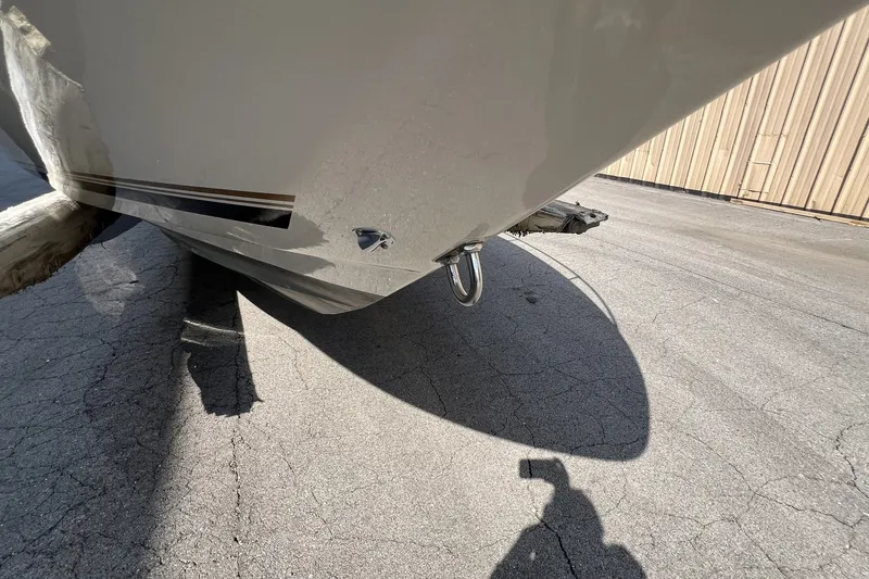Slide: The Image of 1997 Sea Ray 240 Overnighter boat hull on pavement, shadow visible. - 76