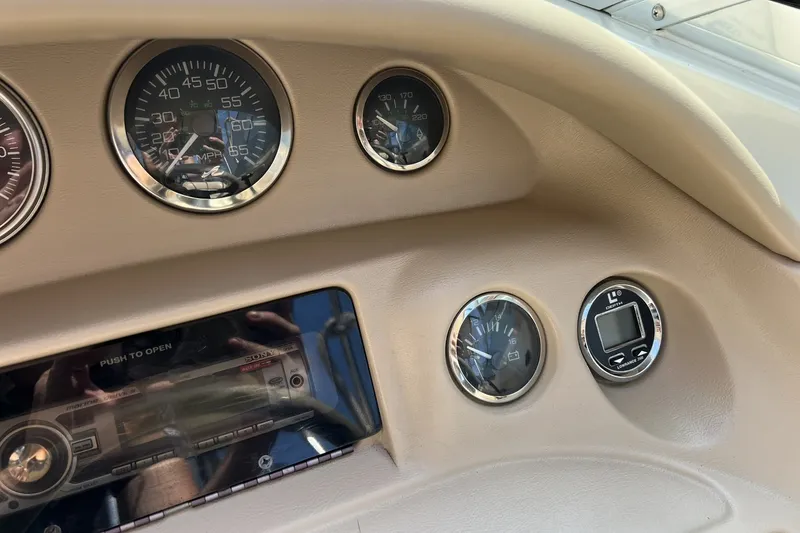 Slide: The Image of Dashboard of a 1997 Sea Ray 240 Overnighter boat with gauges and controls. - 15