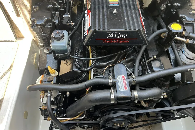 Slide: The Image of Engine of a 1997 Sea Ray 240 Overnighter boat, featuring 7.4L Thunderbolt Ignition. - 100
