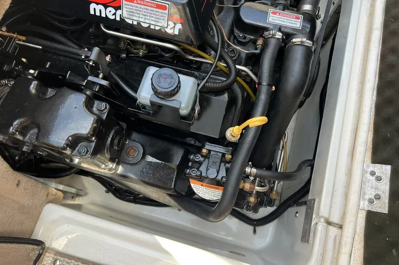 Slide: The Image of Engine compartment of a 1997 Sea Ray 240 Overnighter boat, featuring MerCruiser components. - 98