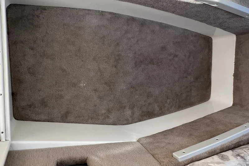 Slide: The Image of Interior cabin of a 1997 Sea Ray 240 Overnighter boat with carpeted flooring. - 51