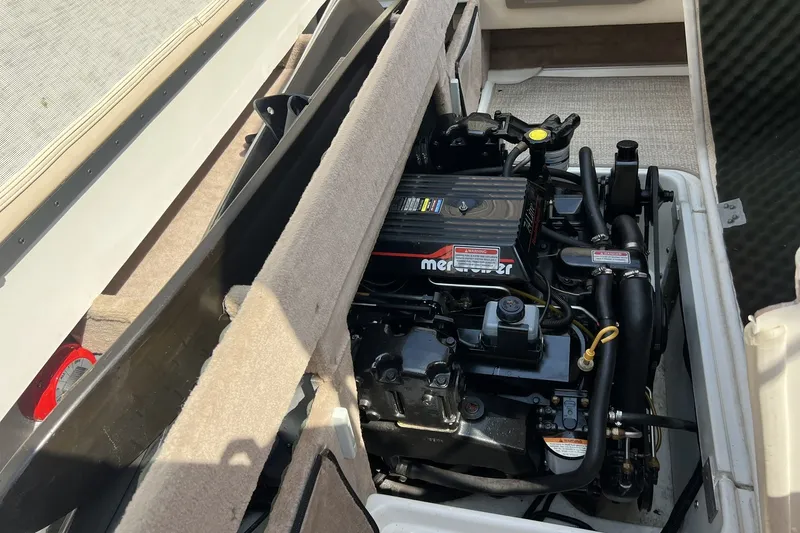 Slide: The Image of Engine compartment of a 1997 Sea Ray 240 Overnighter boat, featuring a MerCruiser engine. - 97