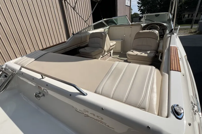 Slide: The Image of 1997 Sea Ray 240 Overnighter boat interior with beige seating and wood accents. - 68