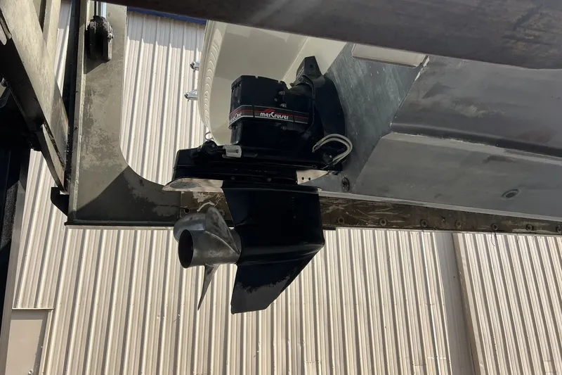 Slide: The Image of 1997 Sea Ray 240 Overnighter boat engine and propeller in a storage facility. - 88