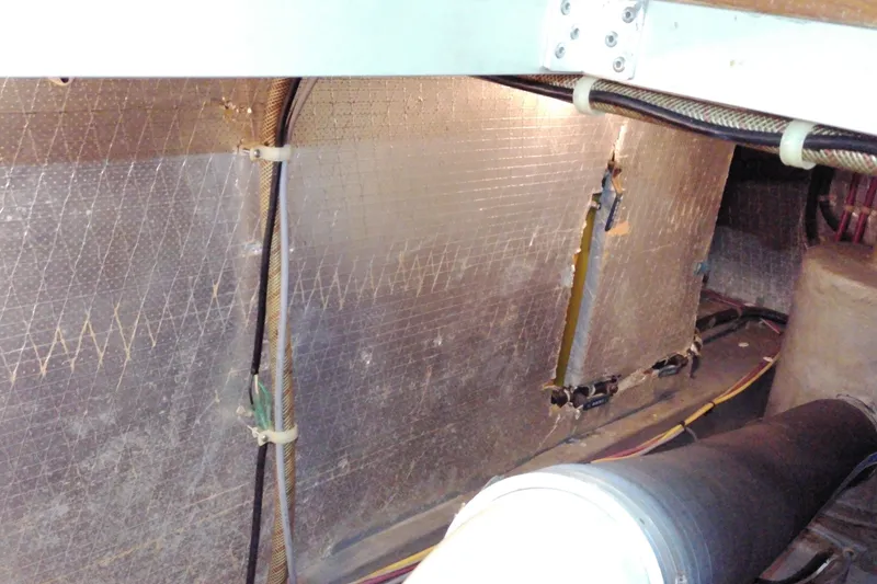 Slide: The Image of Engine compartment of 2005 Mariner 34 Orient boat, showing insulation and wiring. - 32