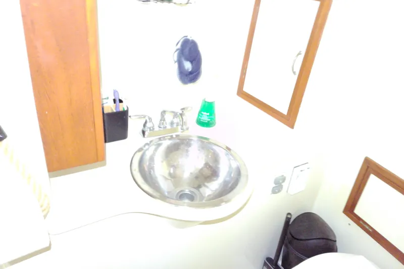Slide: The Image of Small bathroom with stainless steel sink in 2005 Mariner 34 Orient boat. - 23