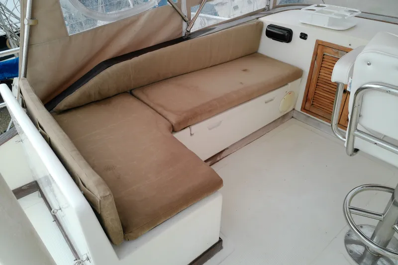 Slide: The Image of Interior seating area of a 2005 Mariner 34 Orient boat with beige cushions. - 39