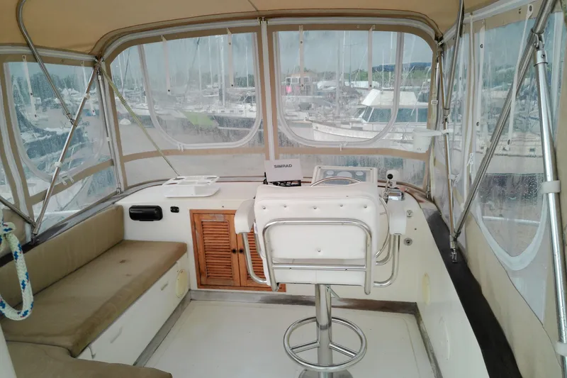 Slide: The Image of Interior view of a 2005 Mariner 34 Orient boat cockpit with seating and helm. - 40