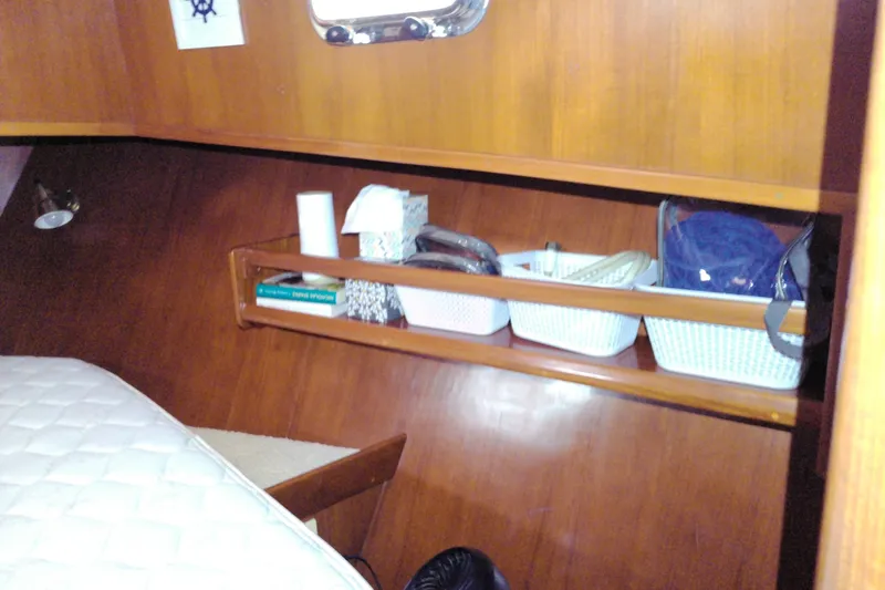 Slide: The Image of Cozy cabin interior of 2005 Mariner 34 Orient yacht with wooden shelves and storage baskets. - 21