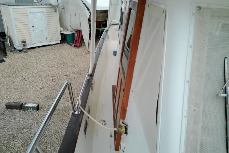Slide: The Image of 2005 Mariner 34 Orient boat deck with railing and wooden door. - 15
