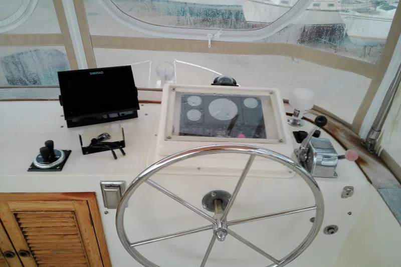 Slide: The Image of Helm of 2005 Mariner 34 Orient boat with steering wheel and navigation equipment. - 35