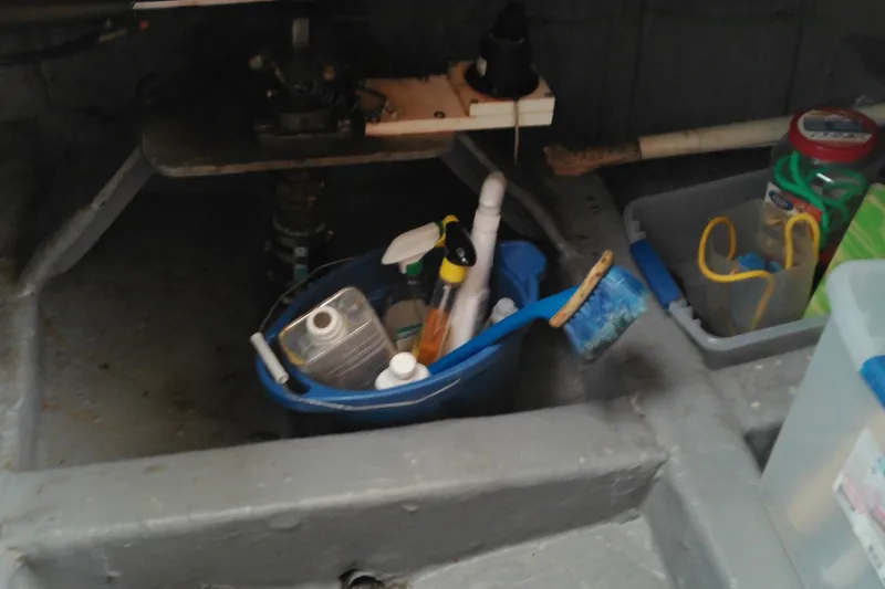 Slide: The Image of Storage area on a 2005 Mariner 34 Orient boat with cleaning supplies and tools. - 19