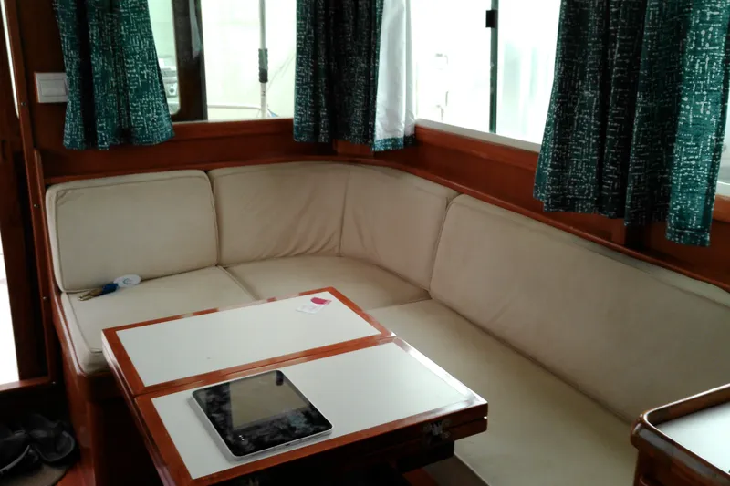 Slide: The Image of Interior of 2005 Mariner 34 Orient yacht with cozy seating and table. - 26