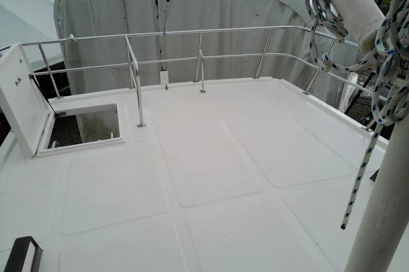Slide: The Image of Deck of 2005 Mariner 34 Orient boat with open hatch and railing. - 42