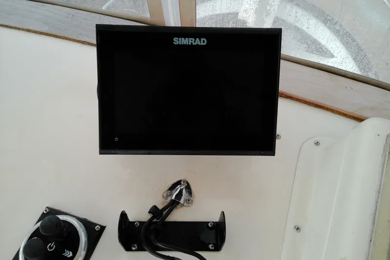 Slide: The Image of Simrad display on 2005 Mariner 34 Orient boat dashboard, featuring navigation controls. - 37