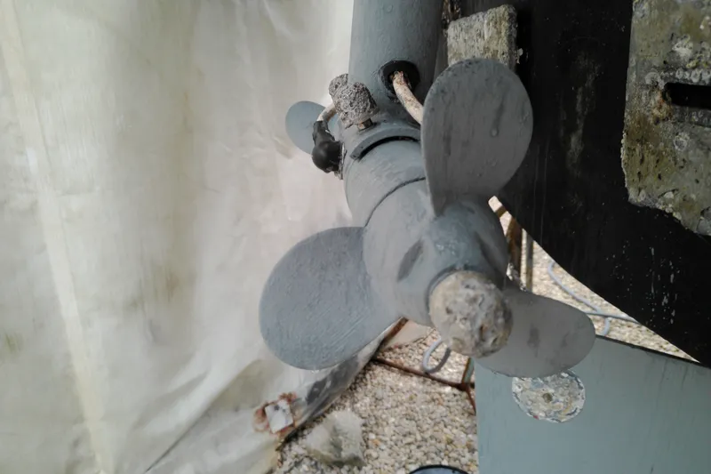 Slide: The Image of Close-up of a 2005 Mariner 34 Orient boat propeller, showing wear and corrosion. - 8