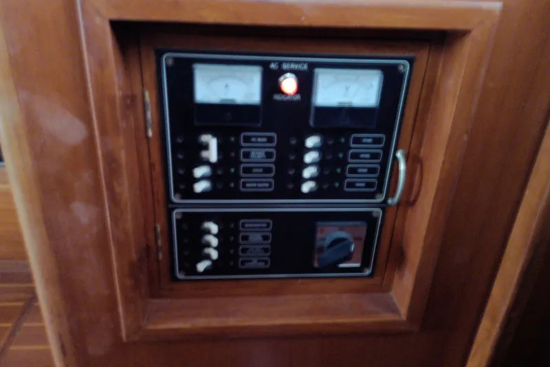 Slide: The Image of Electrical panel on a 2005 Mariner 34 Orient boat, featuring gauges and switches. - 47