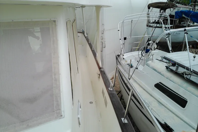 Slide: The Image of Side view of a 2005 Mariner 34 Orient yacht docked beside another boat. - 16