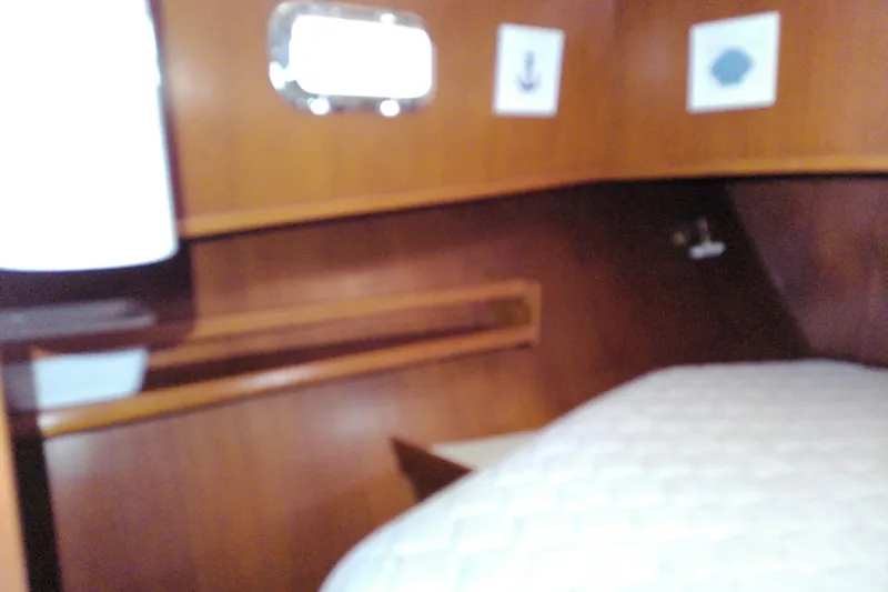 Slide: The Image of Cozy cabin interior of 2005 Mariner 34 Orient yacht with wooden paneling and bed. - 22