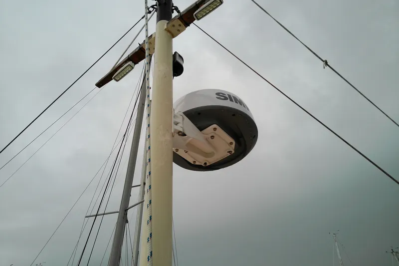 Slide: The Image of Radar equipment on a 2005 Mariner 34 Orient sailboat mast under cloudy skies. - 41