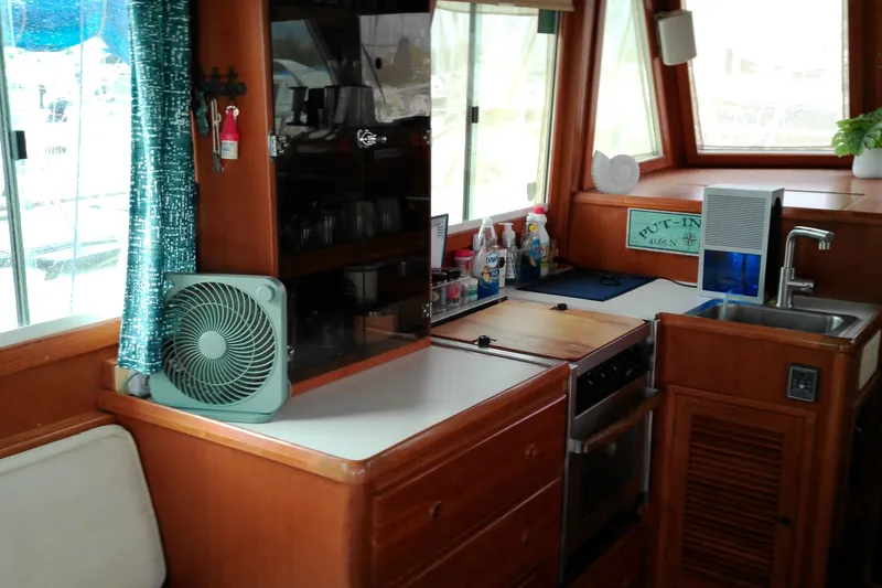 Slide: The Image of Interior of 2005 Mariner 34 Orient yacht kitchen with fan, sink, and appliances. - 28