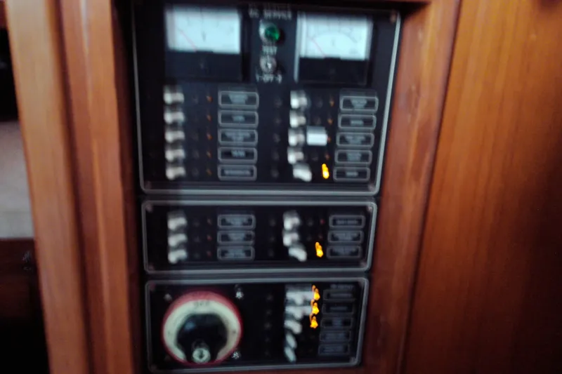 Slide: The Image of Electrical control panel on a 2005 Mariner 34 Orient boat, featuring switches and gauges. - 46
