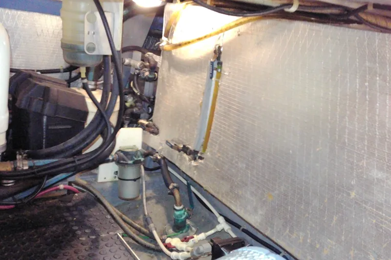 Slide: The Image of Engine compartment of a 2005 Mariner 34 Orient boat, showing various mechanical components. - 31