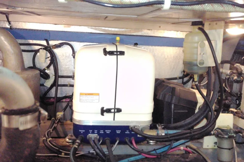 Slide: The Image of Engine room of 2005 Mariner 34 Orient boat, showcasing mechanical components and wiring. - 30