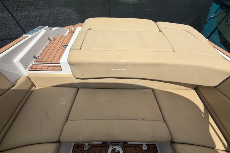 Slide: The Image of 2016 Glastron GT 245 boat interior with beige seating and teak-style flooring. - 19