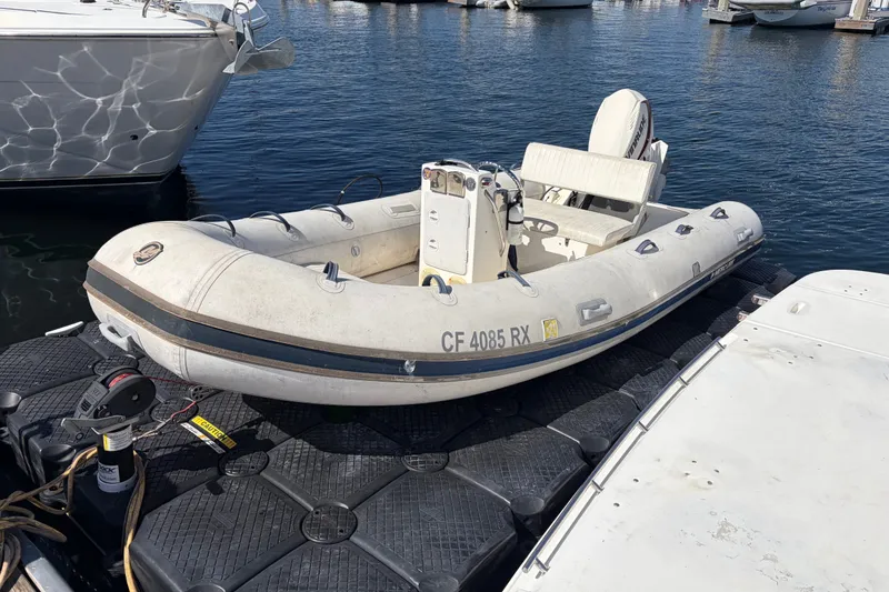 Slide: The Image of Inflatable boat docked beside a 1999 Cruisers Yachts 3870 Esprit in a marina. - 30