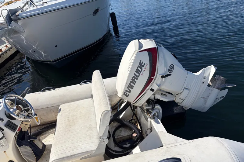Slide: The Image of 1999 Cruisers Yachts 3870 Esprit with Evinrude outboard motor docked on calm water. - 32