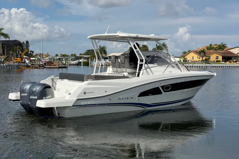 Slide: The Image of 2021 Jeanneau Cap Camarat 9.0 WA boat with twin Yamaha 250 engines on a calm waterway. - 1