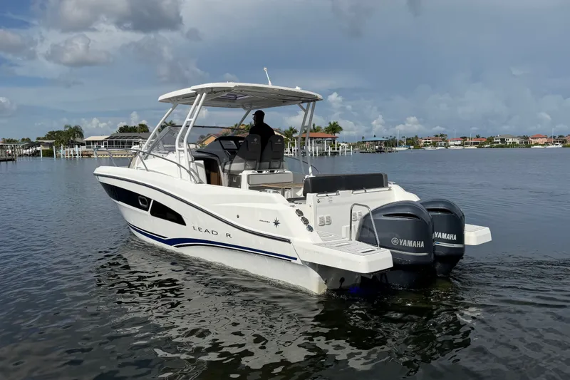 Slide: The Image of 2021 Jeanneau Cap Camarat 9.0 WA boat with twin Yamaha engines on calm water. - 4