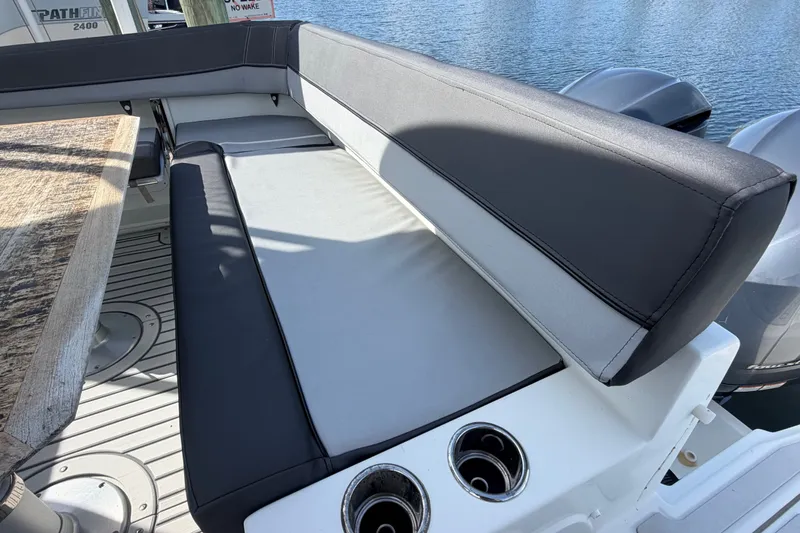 Slide: The Image of 2021 Jeanneau Cap Camarat 9.0 WA boat seating area with table and cup holders. - 25
