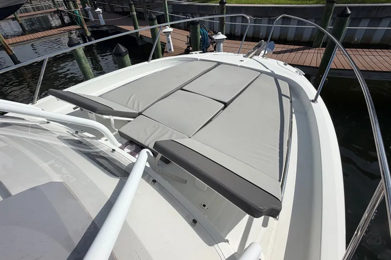 Slide: The Image of 2021 Jeanneau Cap Camarat 9.0 WA boat with cushioned sun deck at marina. - 9