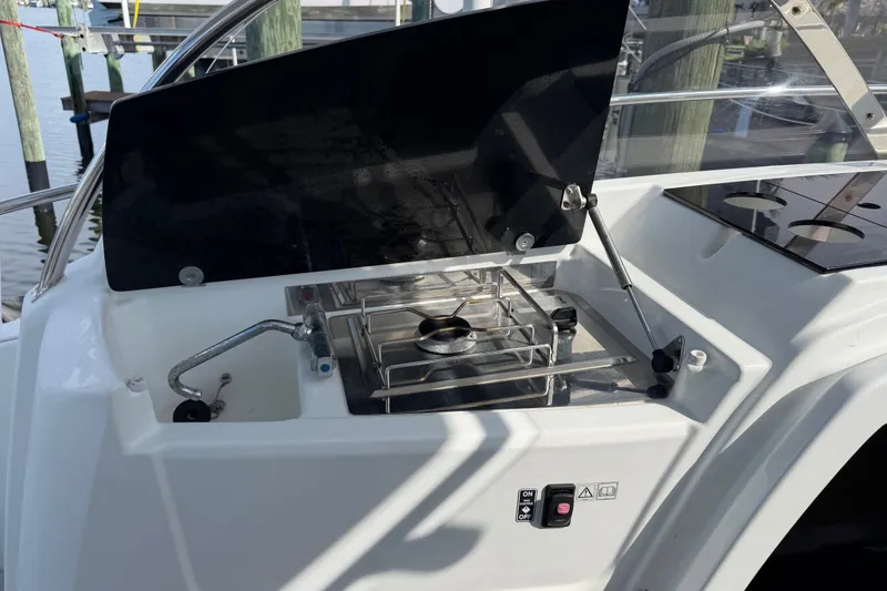 Slide: The Image of Outdoor kitchen on 2021 Jeanneau Cap Camarat 9.0 WA boat with stove and sink. - 22