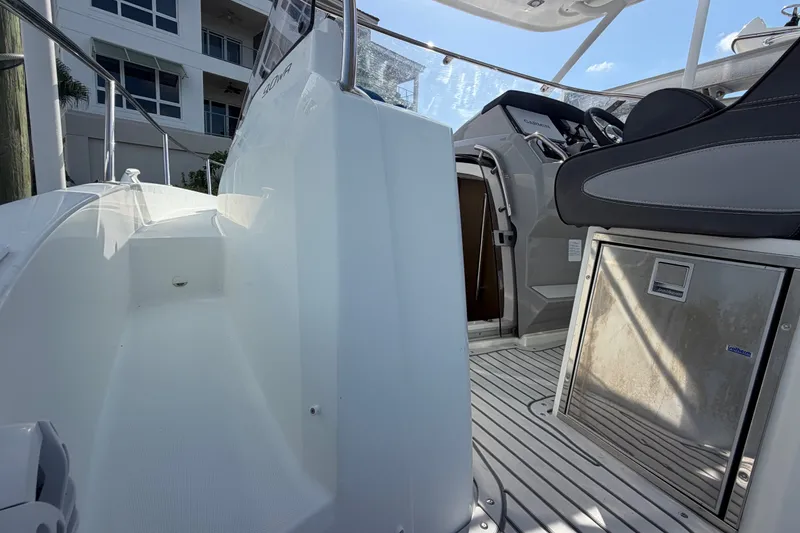 Slide: The Image of 2021 Jeanneau Cap Camarat 9.0 WA boat interior with seating and control panel. - 21