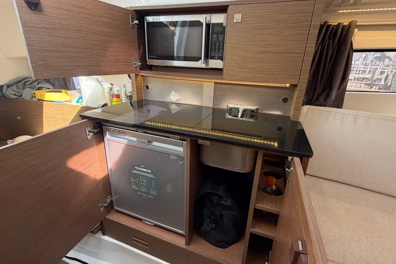 Slide: The Image of Interior of 2021 Jeanneau Cap Camarat 9.0 WA boat with kitchenette and appliances. - 11