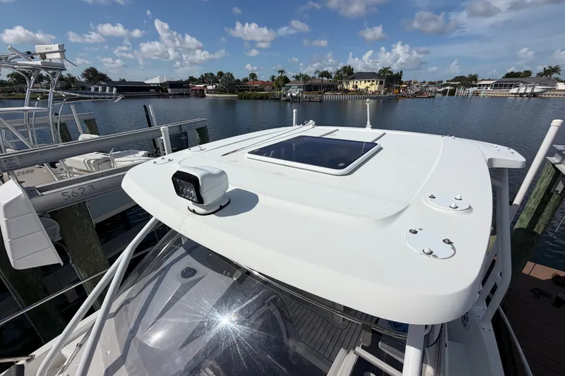 Slide: The Image of 2021 Jeanneau Cap Camarat 9.0 WA boat docked by a scenic waterfront. - 29