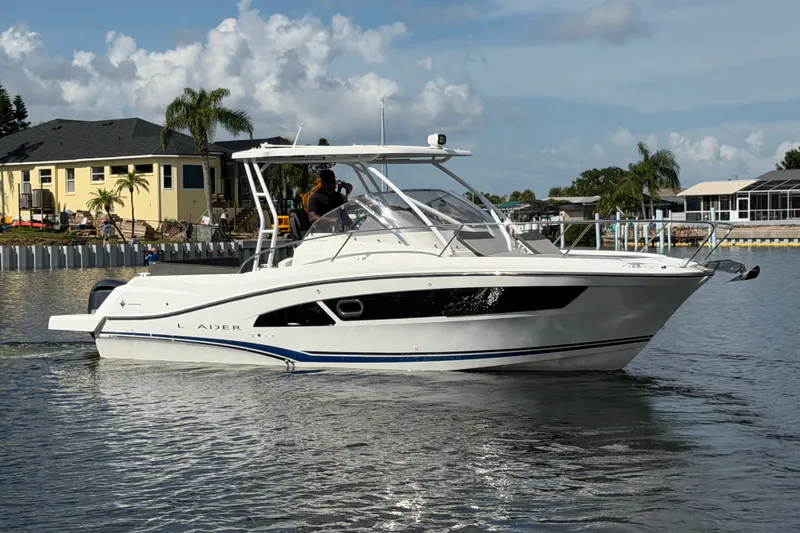 Slide: The Image of 2021 Jeanneau Cap Camarat 9.0 WA boat cruising on a sunny day near waterfront homes. - 6